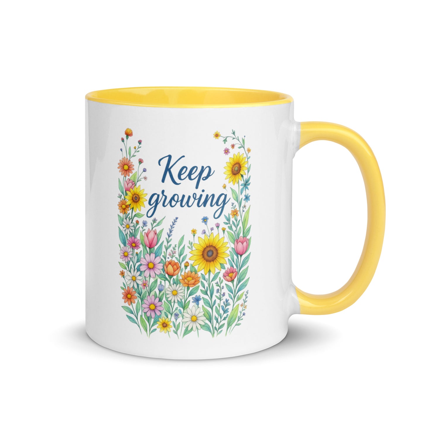 white ceramic mug with yellow handle and colorful floral design with the words "Keep Growing" on the side on a white background