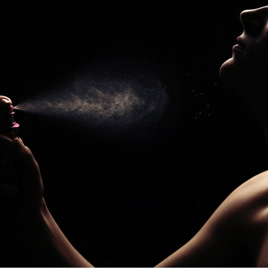 Woman using Elixir Mind Body Botanicals Aromatherapy Spray from Elixir Mind Body Boutique