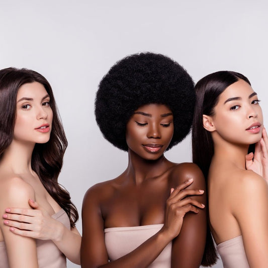 Three women with soft, silky skin after using Elixir Mind Body Botanicals Radiant Massage + Body Oil from Elixir Boutique