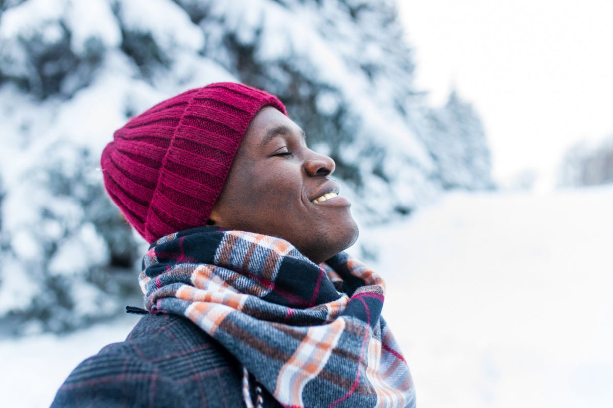 Man outside in the winter after using Elixir Mind Body Botanicals Support Massage + Body Oil to boost his immune system