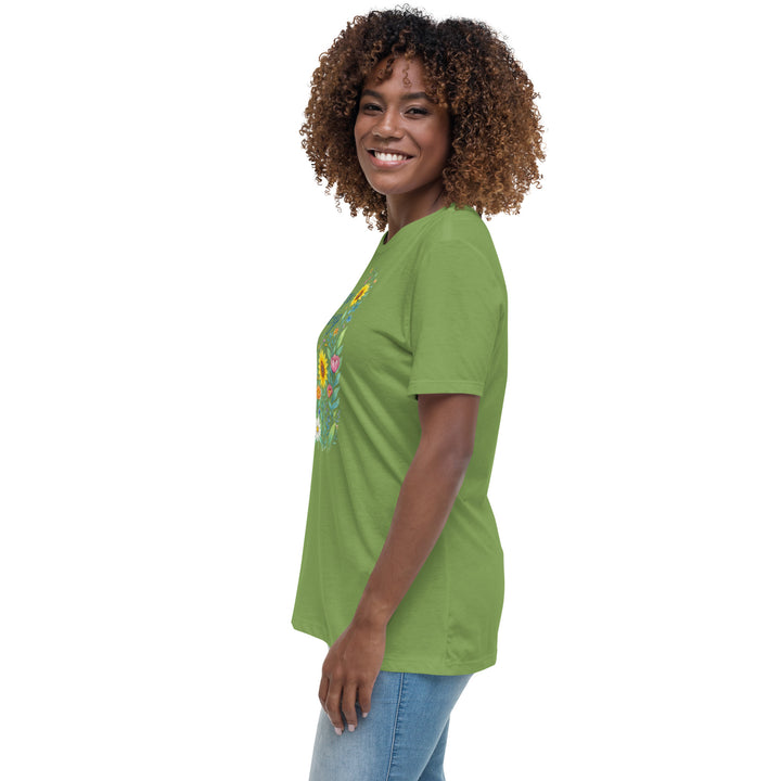 Side view of a smiling woman wearing her relaxed light green short-sleeved t-shirt with a colorful, floral design on the front that says "Keep Growing."