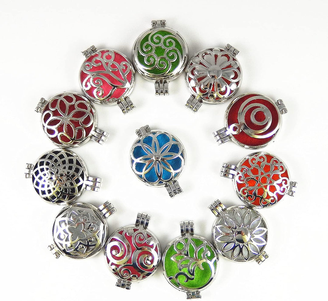 A collection of silver oil diffuser lockets with colorful patterns, displayed on a white background.