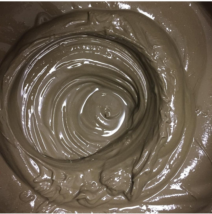 A vat of Elixir Mind Body Botanicals Mineral Mud Mask is being mixed in production
