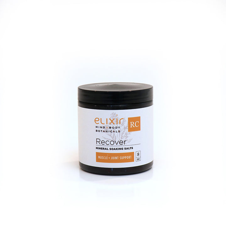 A jar of Elixir Mind Body Botanicals Recover Mineral Soaking Salts on a white background