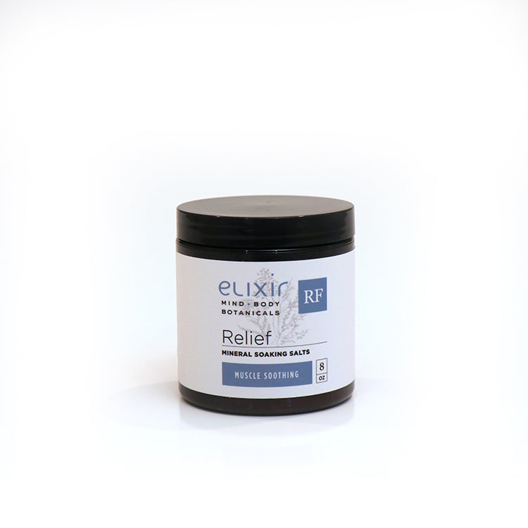 A jar of Elixir Mind Body Botanicals Relief Mineral Soaking Salts on a white background