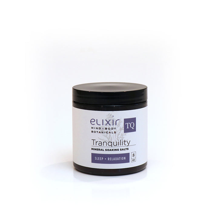 A jar of Elixir Mind Body Botanicals Tranquility Mineral Soaking Salts on a white background