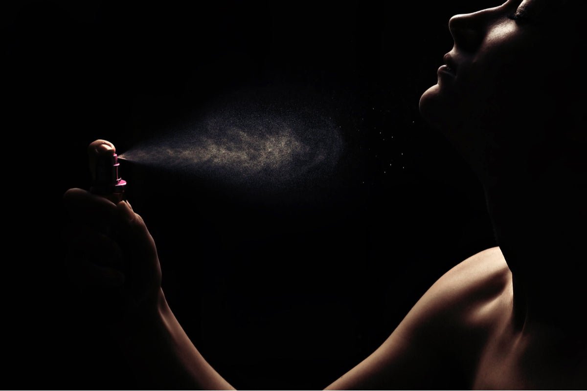 Woman using Elixir Mind Body Botanicals Aromatherapy Spray from Elixir Mind Body Boutique