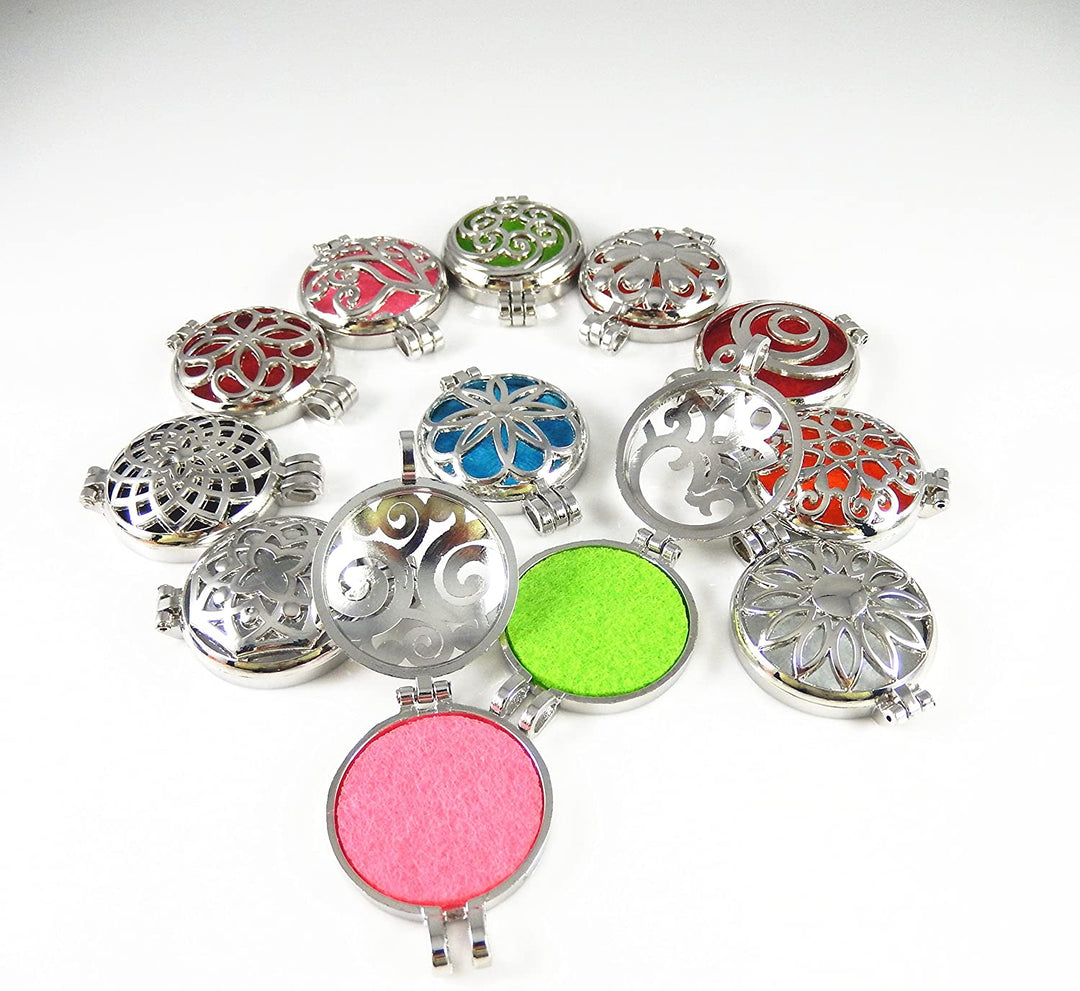 A collection of silver oil diffuser lockets with colorful patterns. Two are open to show the felt pad insert for essential oils, all displayed on a white background.
